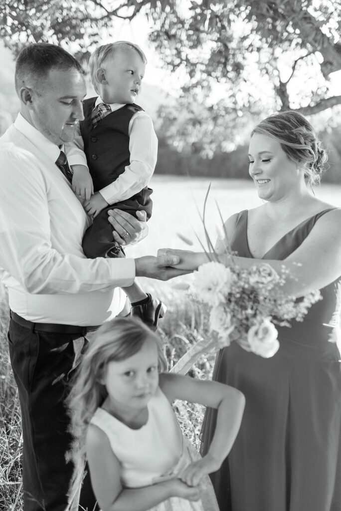 A black and white photo of a ring warming ceremony is shown at a wedding in Cades Cove TN in Smoky Mountains National Park